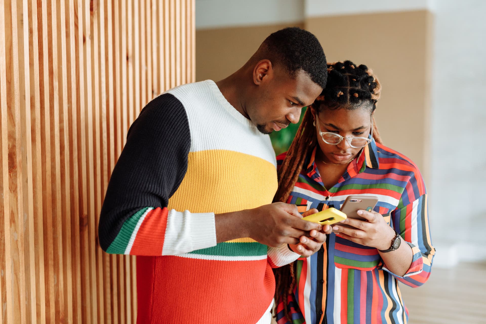 University students using smartphones together on campus