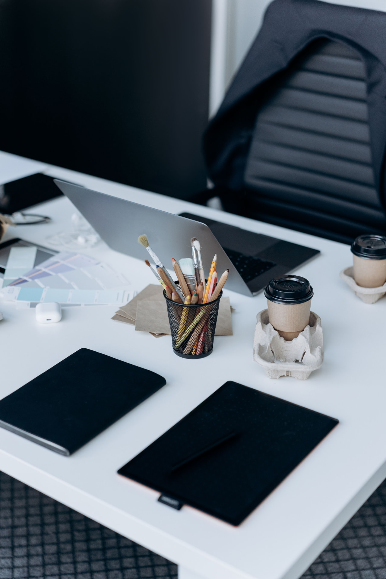 Modern office desk with a laptop in a softly lit workspace